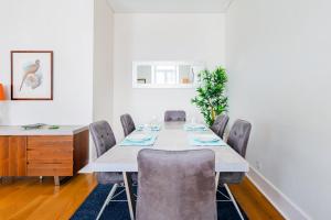 a dining room with a long table and chairs at Downtown 75 Prestige in Baixa in Lisbon