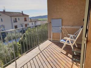 a balcony with a chair and a view at Résidence Lou Cigaloun - ANA LOCATION in Gréoux-les-Bains