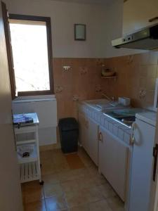 a small kitchen with a sink and a window at Résidence Lou Cigaloun - ANA LOCATION in Gréoux-les-Bains