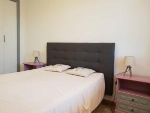 a bedroom with a large white bed with two night stands at Résidence Lou Cigaloun - ANA LOCATION in Gréoux-les-Bains