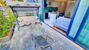 a patio with a table and chairs and a kitchen at Letstay Sweet Home Mint in Antalya