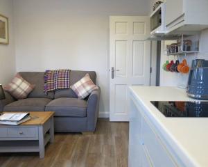a living room with a couch and a table at The Middlewood - Luxury self contained retreat in Adlington