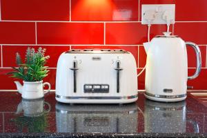 a toaster and coffee maker on a kitchen counter at Modern apartment close to city centre with parking in Leeds