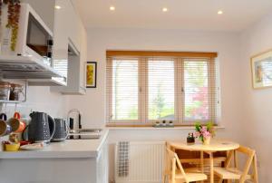 uma cozinha com uma pequena mesa numa cozinha em The Middlewood - Luxury self contained retreat em Adlington