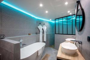a bathroom with a white tub and a sink at Best Western Plus Opéra Batignolles in Paris +28 photos