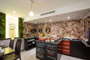 a restaurant kitchen with a counter with a menu at Best Western Plus Opéra Batignolles in Paris