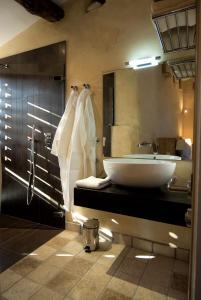 a bathroom with a sink and a large mirror at Hameau de Pichovet in Vachères