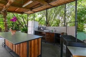 uma cozinha exterior com uma mesa e um frigorífico em YalaRent Valley view complex In Merhavia with Private Pool em Merhavyāh