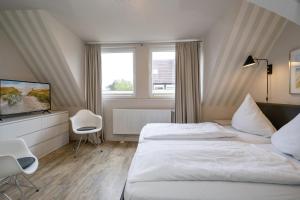 Ein Bett oder Betten in einem Zimmer der Unterkunft Süderliebe