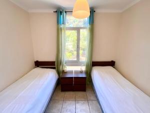 two beds in a room with a window at Apartamento C4 in Tossa de Mar
