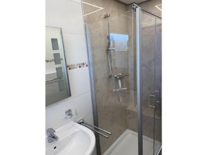a bathroom with a shower and a sink at Möwenblick - a57230 in Cuxhaven