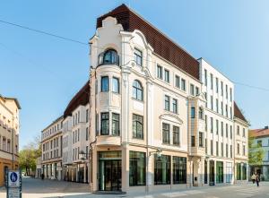 a large white building on the corner of a street at Hotel Schillerhof, Weimar in Weimar