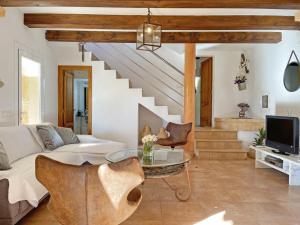 a living room with a couch and a table at Finca Caseta Des Pradi Biel in Lloseta
