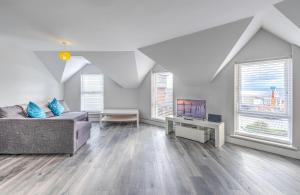 a living room with a couch and a table at APARTMENT 2 and 4 - PORTRUSH MARINE APARTMENTS in Portrush