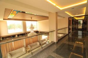 a lobby with couches and a large window at RAMRATHNA RESIDENCY in Madurai