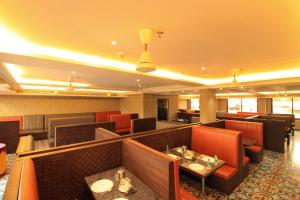 a restaurant with red chairs and tables in a room at RAMRATHNA RESIDENCY in Madurai