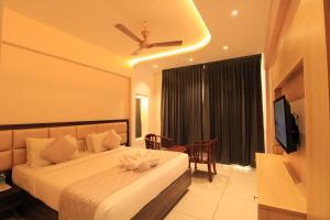 a bedroom with a bed with a ceiling fan at RAMRATHNA RESIDENCY in Madurai
