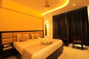 a bedroom with a large bed with a large window at RAMRATHNA RESIDENCY in Madurai +71 photos