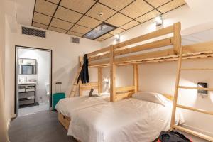 a bedroom with a bunk bed and a bathroom at Ekoos Hostel, Bilbao Eko Hostel in Bilbao