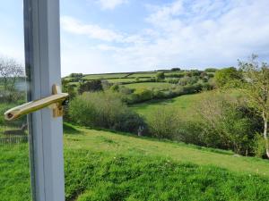 a window with a view of a green field at Highfield House, Parracombe, Modern B&B in Parracombe