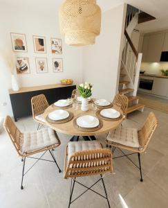 a dining room with a wooden table and chairs at Pine Point Apartament with terrace, shared pool, tennis court in Pobierowo