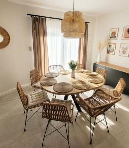 a dining room with a table and chairs at Pine Point Apartament with terrace, shared pool, tennis court in Pobierowo