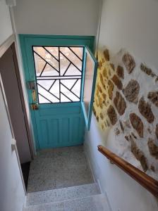 a blue door with a window and a stone wall at Casa Albano in Baldellou