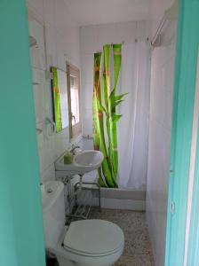 a bathroom with a white toilet and a sink at Casa Albano in Baldellou