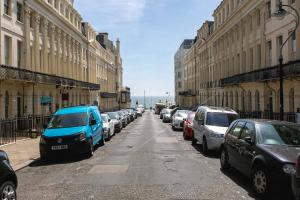 a row of cars parked on a city street at Lovely 2BR AP just moments away from Brighton Beach in Brighton & Hove