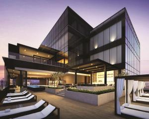 a large black building with white chairs in front of it at Park Hyatt Jakarta in Jakarta