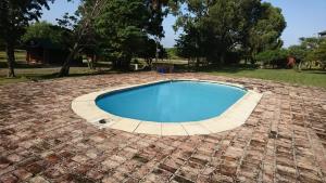 a swimming pool on a brickitiousitiousitiousitiousitiousitiousitiousitiousitiousitious at Cabañas Maria Maria Conchillas in Conchillas