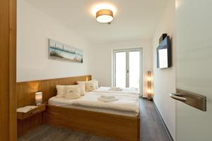 Postel nebo postele na pokoji v ubytování Kells Appartements + 37 fotografií