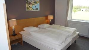 Ein Bett oder Betten in einem Zimmer der Unterkunft Møn Golf Resort - Hotel Præstekilde
