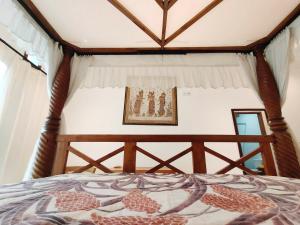 Postel nebo postele na pokoji v ubytování Batik Sekar Bali Guest House