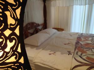 Postel nebo postele na pokoji v ubytování Batik Sekar Bali Guest House