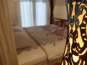 Postel nebo postele na pokoji v ubytování Batik Sekar Bali Guest House