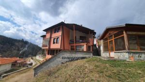 a house sitting on top of a hill at Вила Родопи in Dospat