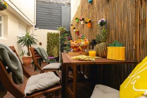 un patio con mesa, sillas y plantas en Lovely 2BR AP just moments away from Brighton Beach, en Brighton & Hove