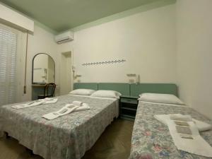 Posteľ alebo postele v izbe v ubytovaní Hotel Nanni Garnì