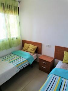 A bed or beds in a room at MH28 - 2 Bedroom apartment, stunning sea views, large terraces in Isla Plana, Puerto de Mazarron