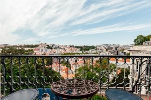 a balcony overlooking a city filled with lots of trees at Torel Palace Lisbon in Lisbon