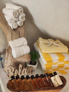 a bathroom with towels and a table with a rack of towels at Il Balconcino sul carugio in Monterosso al Mare