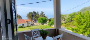 a view from the balcony of a house with a table and chairs at Villa Andoni in Othonoi