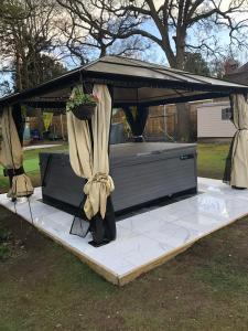 a gazebo with a potted plant on it at Rainbow 3BR flat & luxury Spa option in Bournemouth