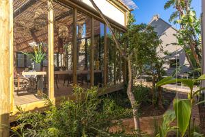 a house with a conservatory in a garden at Val de Vine in Stellenbosch