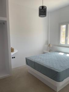 A bed or beds in a room at Voras Villa Panagia Beach