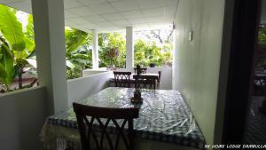 a table and chairs sitting on a balcony with a table and chairs at 98 Home Lodge Dambulla in Dambulla