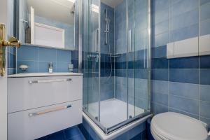 a bathroom with a toilet and a glass shower at Mama Home Apartment W26 in St. Gallen