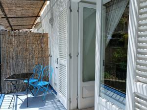 a patio with two chairs and a table on a balcony at Regina Margherita in Positano