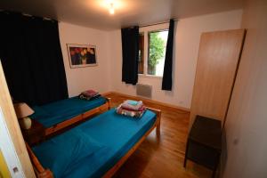 a room with two beds and a window at Essentiel Barret in Barret-sur-Meouge